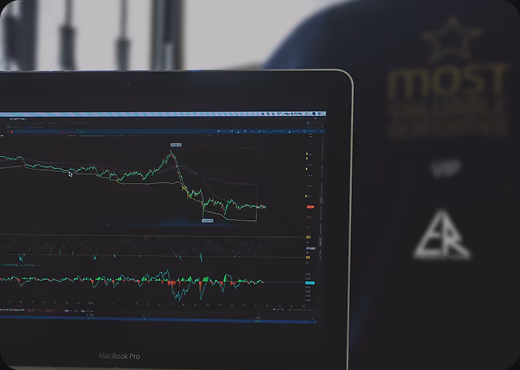 A laptop screen showing time-series charts against a dark dashboard.